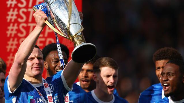 Colby Bishop with the League One trophy 