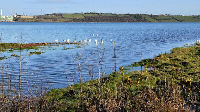 The Glynn River flowing into the tidal Larne Lough two minutes after high water Larne.  Ballylumford power stations are at the top left of the picture