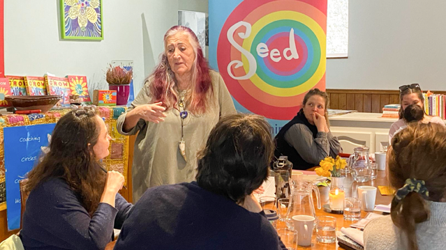 Lynne Franks talking to women sat at a table