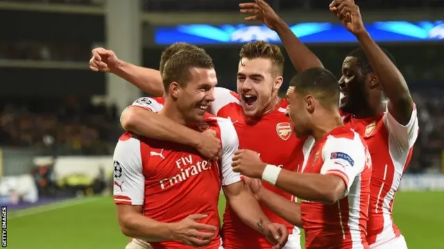Lukas Podolski celebrates with teammates