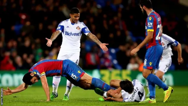 Mile Jedinak makes a tackle