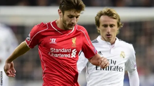 Adam Lallana and Luka Modric fight for the ball