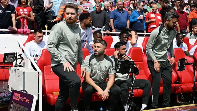 Calum McFarlane looks on from the bench before the match between Liverpool and Chelsea at Anfield