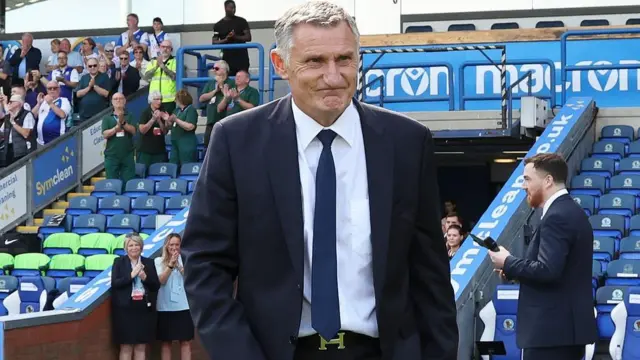 Tony Mowbray walks to be presented with his Blackburn Rovers Honour Cap at Ewood Park before a game against Birmingham City in August 2025.