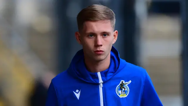 Jake Garrett donning a blue Bristol Rovers training hoodie before a match