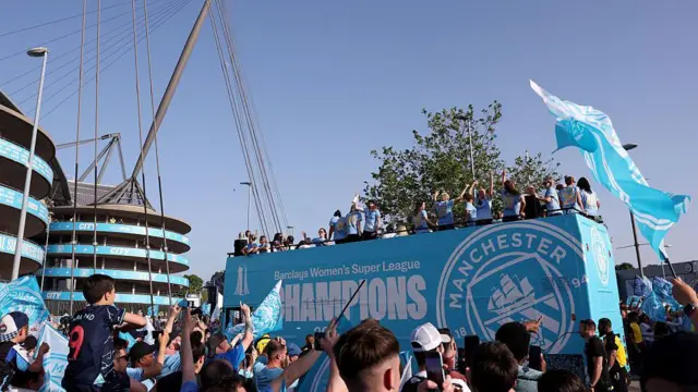 The open-top bus parade reaching Etihad Stadium