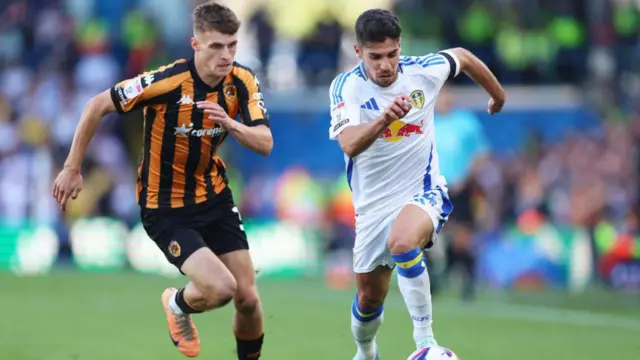 Manor Solomon of Leeds United is challenged by Will Jarvis of Hull City