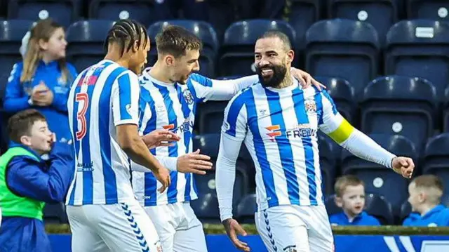 KILMARNOCK, SCOTLAND - DECEMBER 26: Kilmarnock's Kyle Vassell (R) celebrates scoring to make it 1-0 with teammates Corrie Ndaba (L) and Brad Lyons during a William Hill Premiership match between Kilmarnock and Aberdeen at Rugby Park, on December 26, 2024, in Kilmarnock, Scotland. (Photo by Roddy Scott / SNS Group)