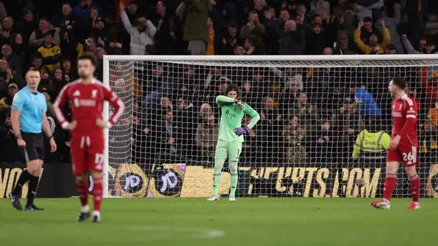 Alisson Becker of Liverpool looks dejected