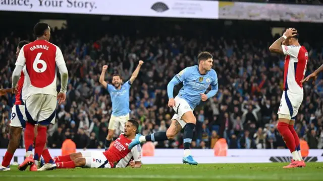 John Stones scores the late equaliser for Manchester City against Arsenal. 