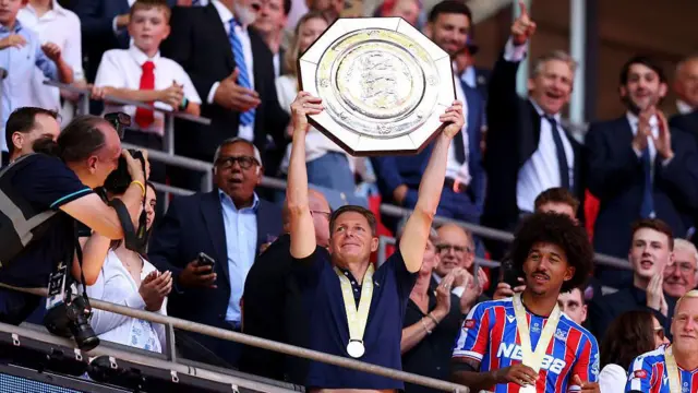 Oliver Glasner celebrates lifts the FA Community Shield