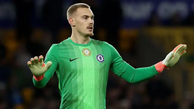 Filip Jorgensen gesturing for calmness to his defence against Wolves