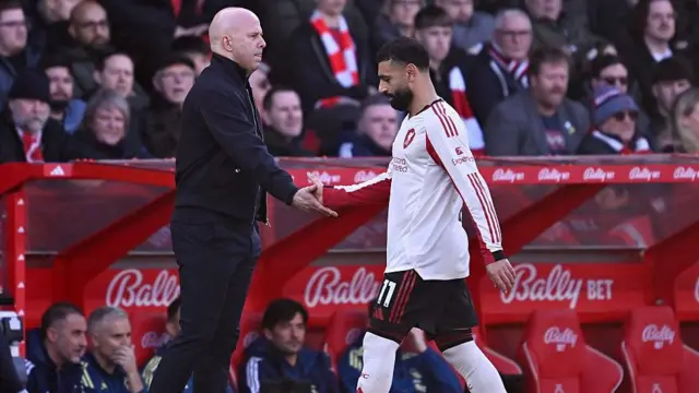 Mohamed Salah of Liverpool shakes hands with Arne Slot