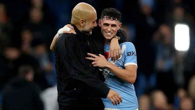 Pep Guardiola, Manager of Manchester City and Phil Foden of Manchester City 