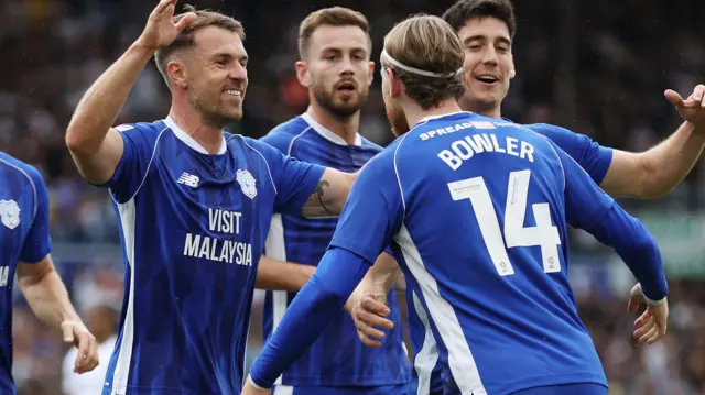 Josh Bowler (right) celebrates a Cardiff City goal with Aaron Ramsey (left)