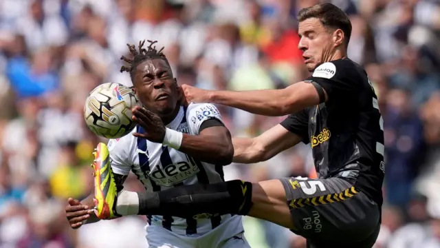 West Bromwich Albion and Southampton players challenge for the ball