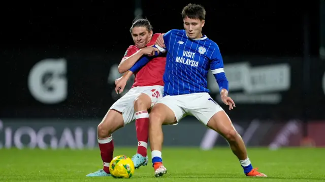 Wrexham's George Dobson and Cardiff City's Rubin Colwill battle for the ball.