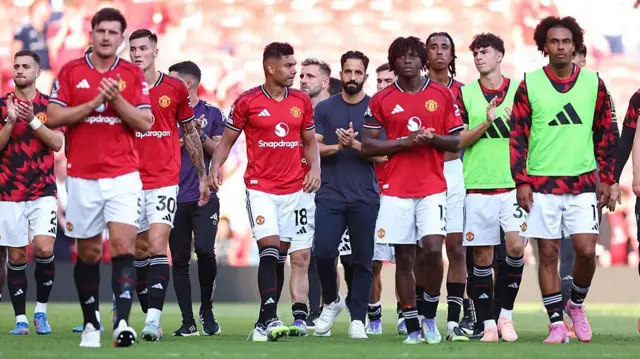 Ruben Amorim the head coach / manager of Manchester United applauds at full time with his players during the Premier League match between Manchester United and Arsenal at Old Trafford