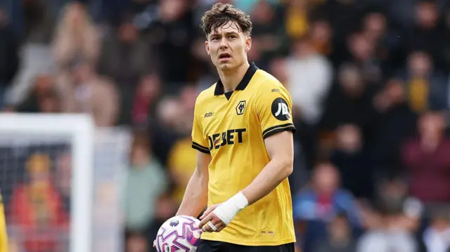 Jorgen Strand Larsen holds the ball and looks on thoughtfully during a match for Wolves
