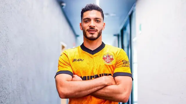 Raul Jimenez poses after re-signing for Wolves