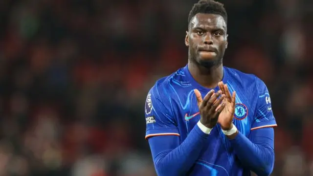 Chelsea's Benoit Badiashile applauds the fans at the final whistle of the Premier League match between Liverpool FC and Chelsea FC at Anfield