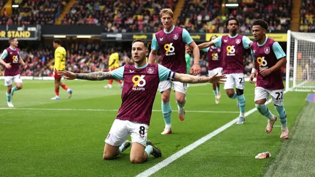 Josh Brownhill celebrates scoring a goal at Vicarage Road by sliding on his knees