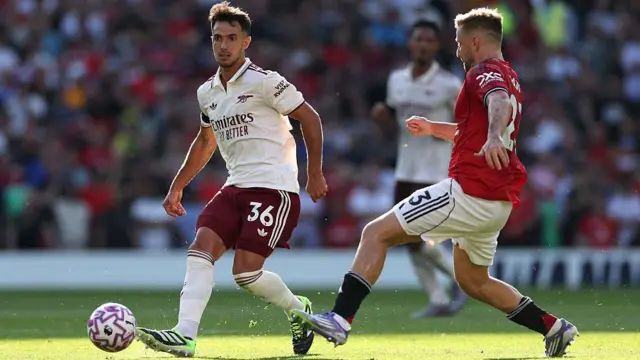 Martin Zubimendi beats Luke Shaw to the ball during the Premier League match between Manchester United and Arsenal at Old Trafford