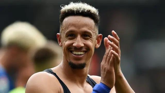 Cardiff City striker Callum Robinson smiles and applauds Cardiff fans