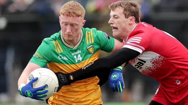 Brendan Rogers challenges Donegal's Oisin Gallen during the Division One game in early March
