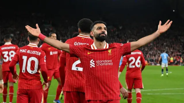 Mohamed Salah celebrating with team-mates after scoring a penalty against Manchester City at Anfield