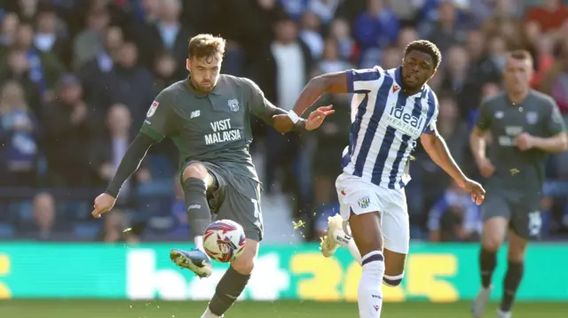 Cardiff City defender Calum Chambers (L) battles with West Brom forward Josh Maja