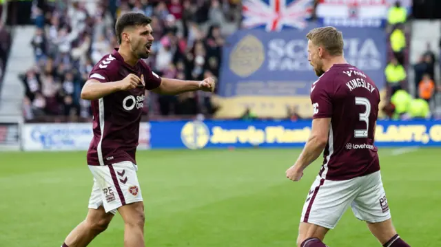 Claudio Braga and Stephen Kingsley celebrate