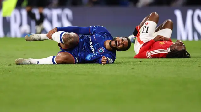Reece James of Chelsea goes down injured during the Premier League match between Chelsea FC and Manchester United FC at Stamford Bridge