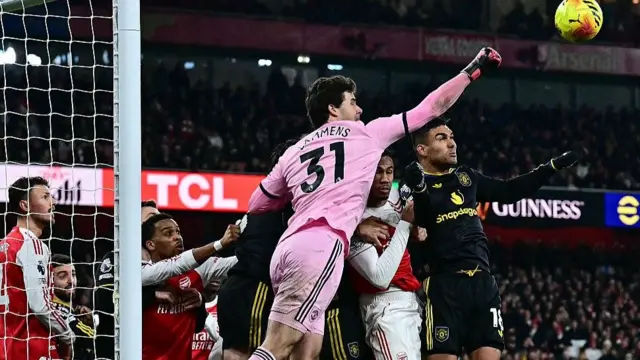 Manchester United goalkeeper Senne Lammens goes to punch the ball out of his penalty area during the 3-2 win against Arsenal at the Emirates Stadium