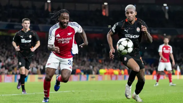 Raheem Sterling and Pedro Enrique of Shakhtar Donetsk chase the ball down