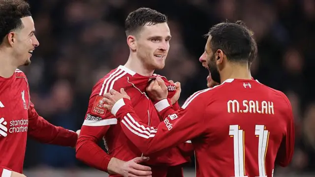 Liverpool players celebrating with Andy Robertson