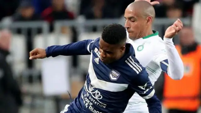 Bordeauxs Togolese forward Thibault Klidje (L) fights for the ball with Saint Etienne's Tunisian midfielder Wahbi Khazri during the French L1 football match between Bordeaux and Saint-Etienne at Matmut Atlantique stadium in Bordeaux 