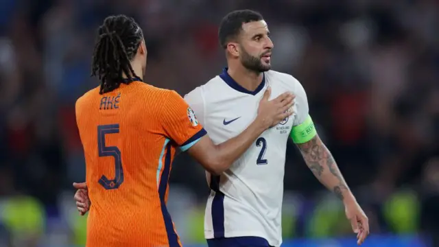 Nathan Ake of the Netherlands and Kyle Walker of England embrace