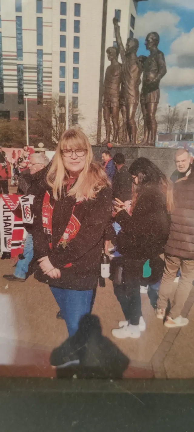 Picture of Manchester United supporter Stephen's late daughter wearing a Man United scarf at a game at Old Trafford.