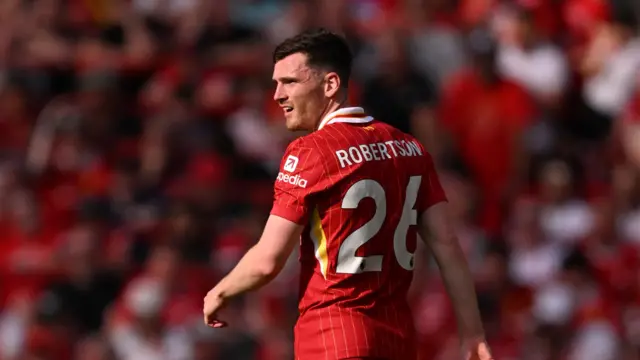 Andy Robertson looks on in the sunshine