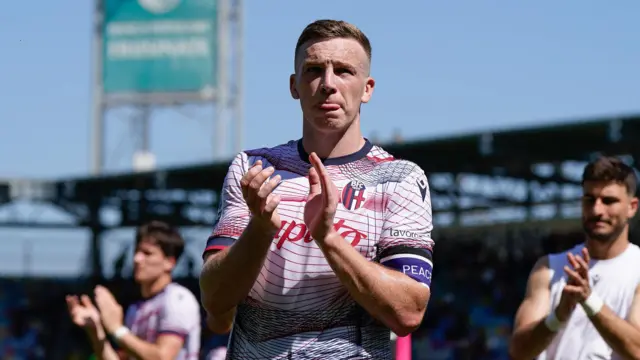 Lewis Ferguson applauds Bologna fans