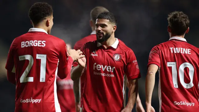 Bristol City midfielder Sam Morsy grabs the hand of team-mate Neto Borges
