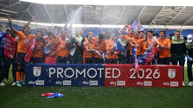 Cardiff City players celebrating promotion after beating Reading 3-1.