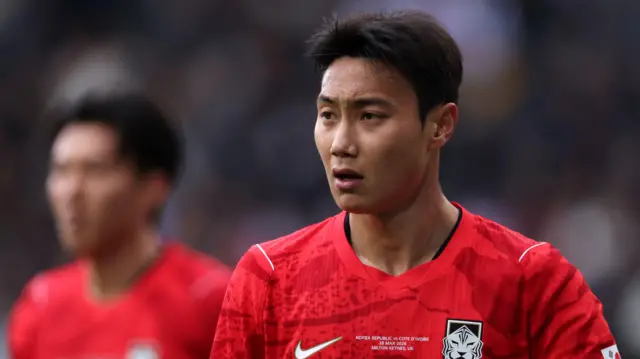 A close-up of Paik Seung-ho playing for South Korea in their red kit