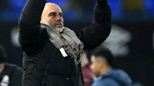 Pep Guardiola puts thumbs up to the crowd after win