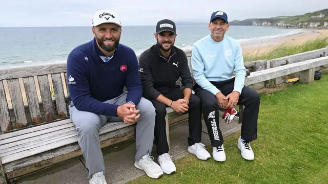 From left to right - Jon Rahm, Angel Hidalgo and Sergio Garcia sat on the famous bench at the 16th hole of Royal Portrush.