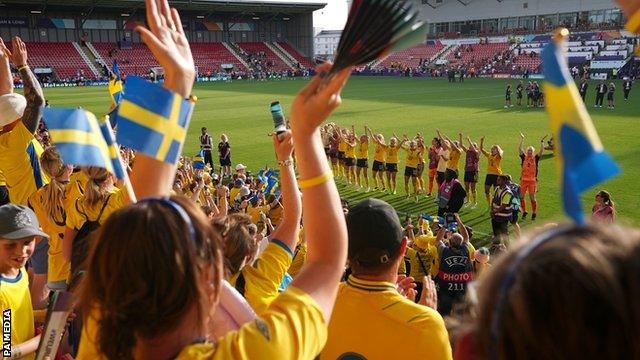 Sweden's players celebrate in front of their fans after defeating Portugal to finish top of Group C at Euro 2022