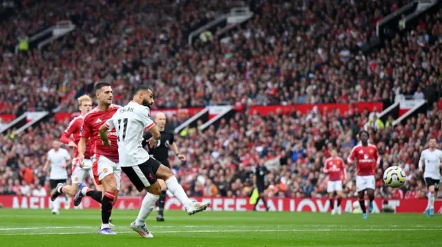 Mohamed Salah of Liverpool scores his team's third goal