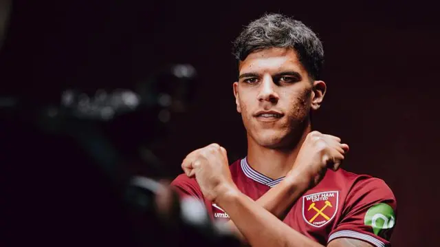 Mateus Fernandes makes Hammers sign with arms in front of camera
