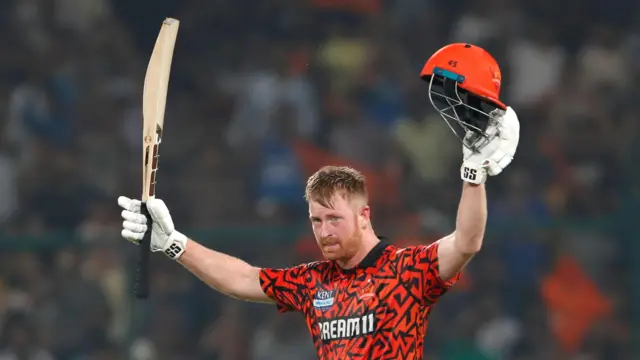 Heinrich Klaasen holds his bat and helmet aloft
